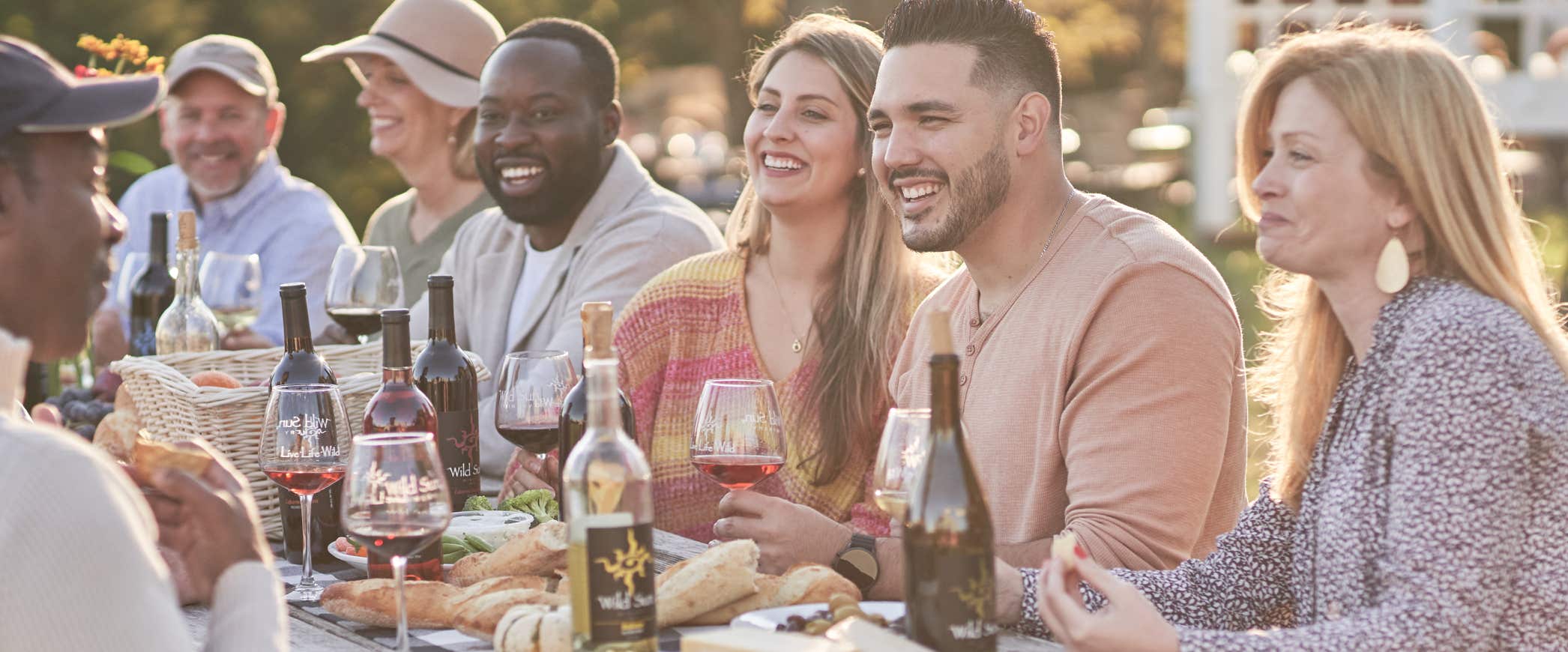 People enjoying food and wine outside at Wild Sun Winery and Brewery